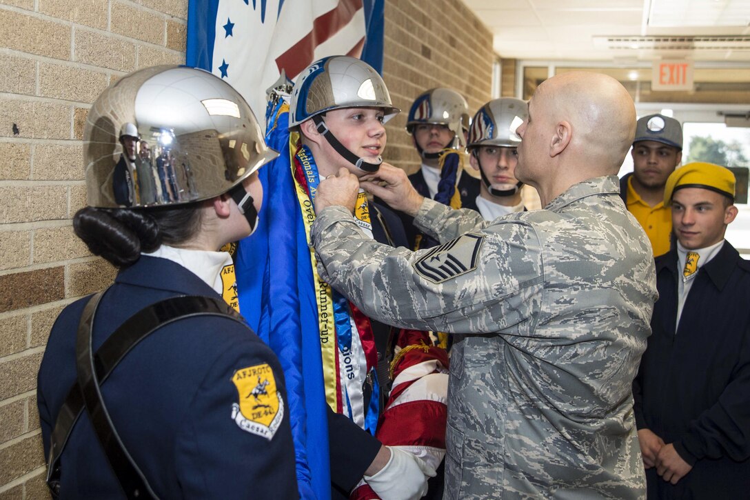 Air Force Master Sgt. Jon Wedel adjusts the ascot on Cadet Taylor Mathew before the colors demonstration during the 2017 Delaware State JROTC Drill Competition at Dover Air Force Base, Del., April 8, 2017. Cadets from the Caesar Rodney JROTC color guard presented the colors at the morning ceremony. Air Force photo by Staff Sgt. Jared Duhon