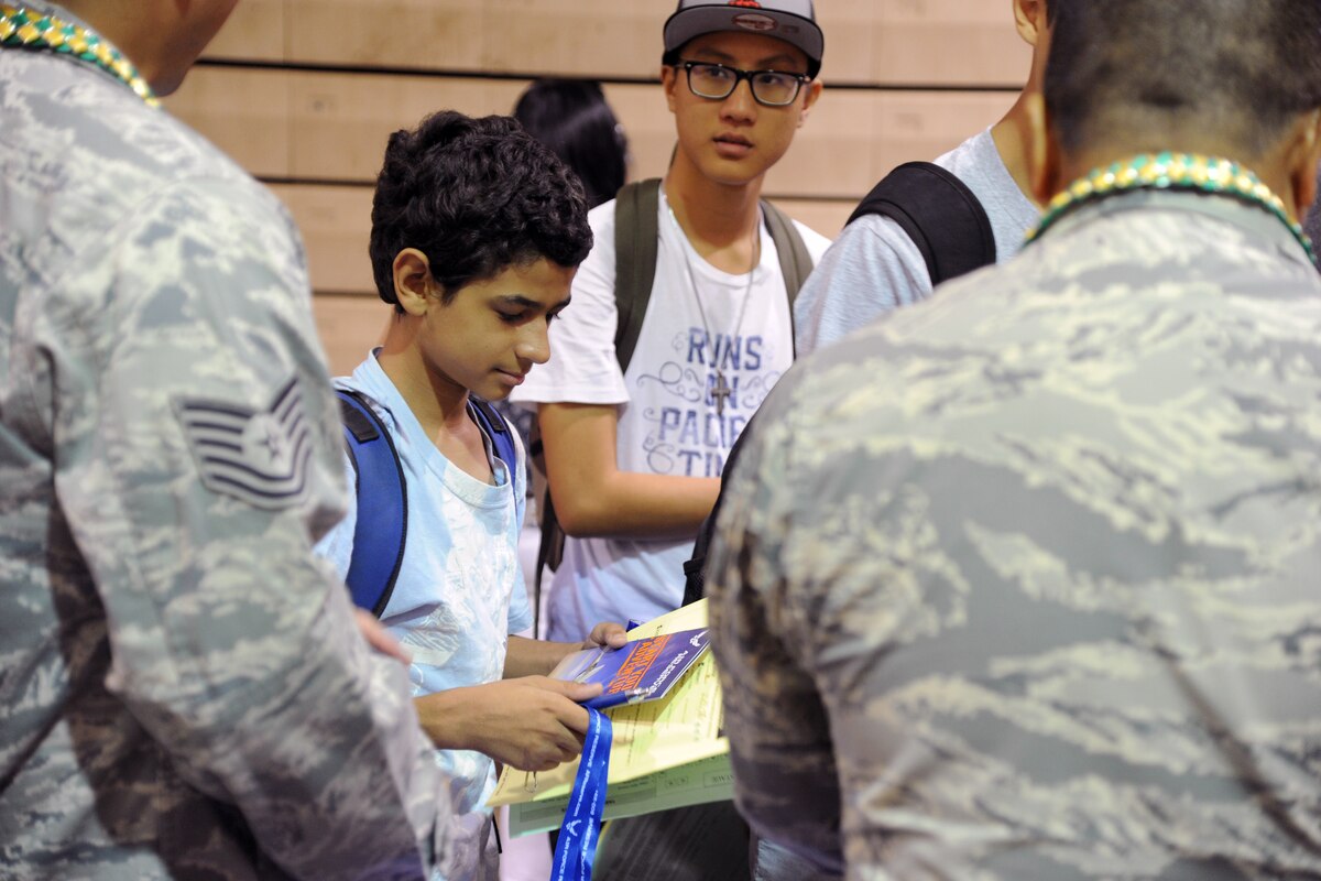 A Kaimuki High School student learns more about the Air Force Reserve from members of the 624th Regional Support Group during the school’s career fair at Kaimuki High School, Honolulu, Hawaii, Jan. 27, 2017. Eleven Airmen from the 624th Regional Support Group volunteered alongside the local recruiting station in support of the fair, which provided career guidance to more than 800 Hawaii students. Located on Oahu and Guam, and a component of the Air Force Reserve, the 624th Regional Support Group's mission is to deliver mission essential capability through combat readiness, quality management and peacetime deployments in the Pacific area of responsibility. (U.S. Air Force photo by Master Sgt. Theanne Herrmann)