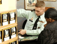 A recruiter walks a young man through the recruiting process at a recruitment office. 